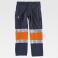 Pantalón softshell alta visibilidad multibolsillos unisex S9820. Color azul marino/naranja a. V..