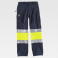 Pantalón softshell alta visibilidad multibolsillos unisex S9820. Color azul marino/amarillo a. V..